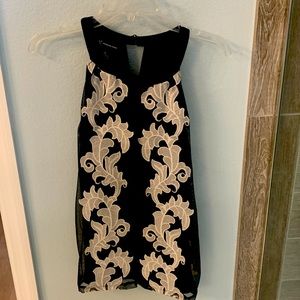 Black sleeveless top with cream floral design-shoulder flattering cut.